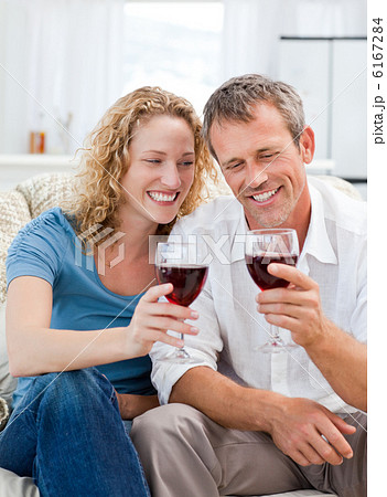Couple drinking some red wine in the living room 6167284