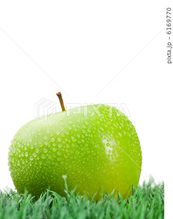 Green wet apple on grass 6169770