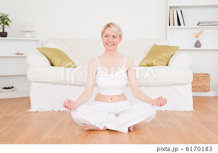 Attractive blonde woman practicing yoga 6170183