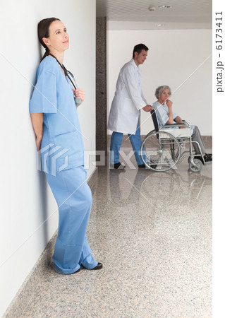 Nurse leaning against wall 6173411