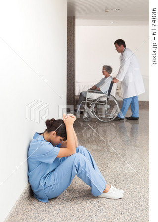 Nurse sitting in the hallway getting depressed Nurse sitting in the hallway getting depressed 6174086