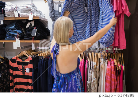 Woman looking through clothes Woman looking through clothes 6174899