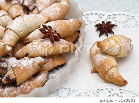 Freshly baked croissants with powdered sugar. Freshly baked croissants with powdered sugar. 6180903