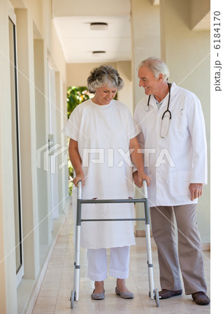 Doctor walking with his patient Doctor walking with his patient 6184170