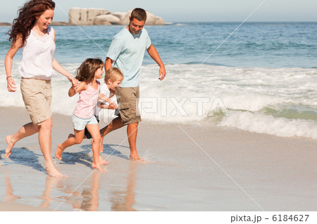 Family running on the beach Family running on the beach 6184627