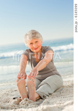 Elderly woman doing her streches Elderly woman doing her streches 6185099