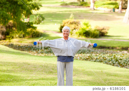 Mature woman doing her exercises in the park 6186101