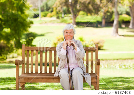 Woman with her walking stick in the park Woman with her walking stick in the park 6187468