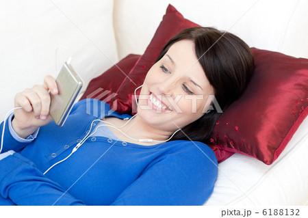 Smiling woman listening music with headphones 6188132