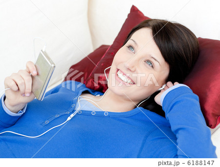 Joyful woman listening music with headphones Joyful woman listening music with headphones 6188147
