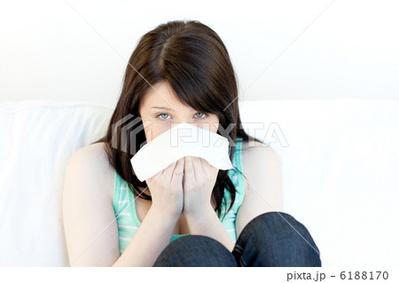 Portrait of a sick attractive woman blowing Portrait of a sick attractive woman blowing 6188170