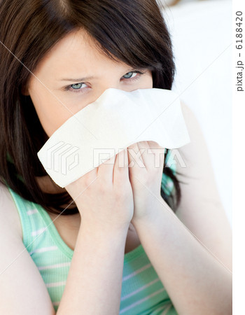 Portrait of a sick caucasian teen girl blowing Portrait of a sick caucasian teen girl blowing 6188420