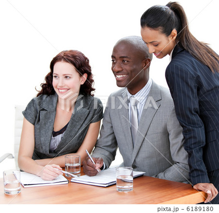 Positive business co-workers studying a document Positive business co-workers studying a document 6189180