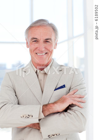 Close-up of a confident senior businessman with folded arms Close-up of a confident senior businessman with folded arms 6189502