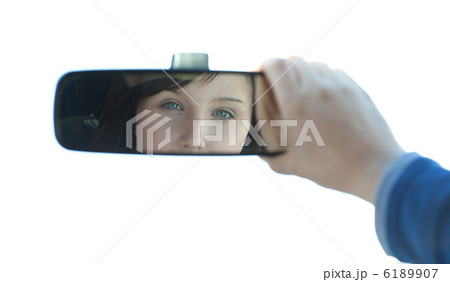 Brunette woman looking in the rear-view mirror Brunette woman looking in the rear-view mirror 6189907