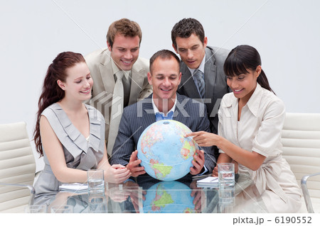 Business team holding a terrestrial globe 6190552