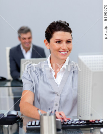 Smiling business woman working at a computer Smiling business woman working at a computer 6190679