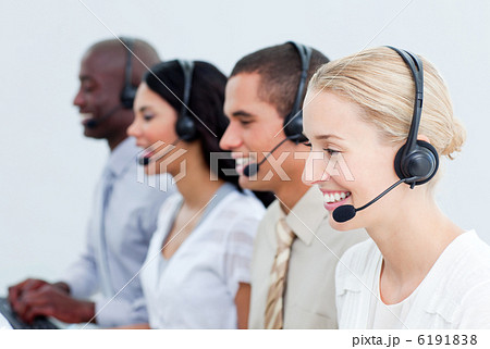 Portrait of smiling business people working in a call center Portrait of smiling business people working in a call center 6191838