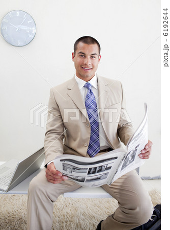 Charming manager reading a newspaper 6192644