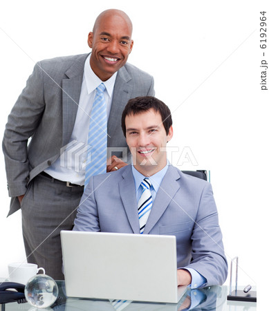 Smiling manager assisting his colleague at a computer Smiling manager assisting his colleague at a computer 6192964