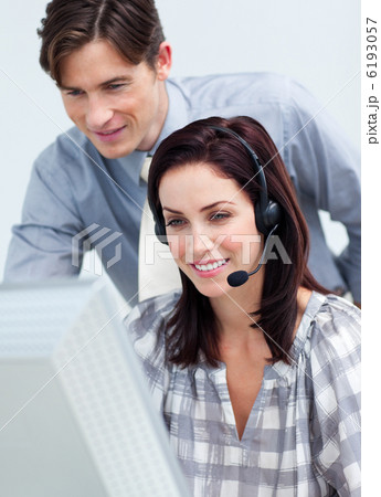 Smiling young manager checking his employee's work 6193057