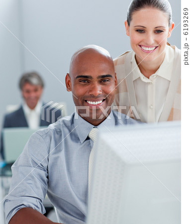 Two positive business colleagues working at a computer 6193269