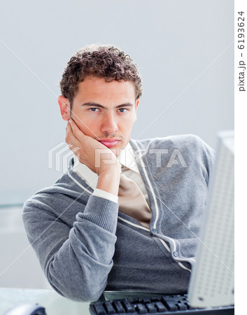 Portrait of a young businessman getting bored at work Portrait of a young businessman getting bored at work 6193624