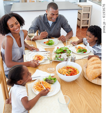 Smiling family dining together 6193676