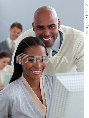 Portrait of two enthusiastic businesspeople working at a compute 6194117