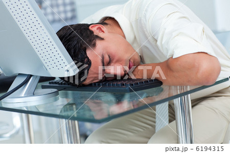 Tired businessman sleeping at his desk 6194315
