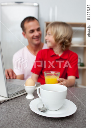 Jolly father and his son having breakfast 6195382