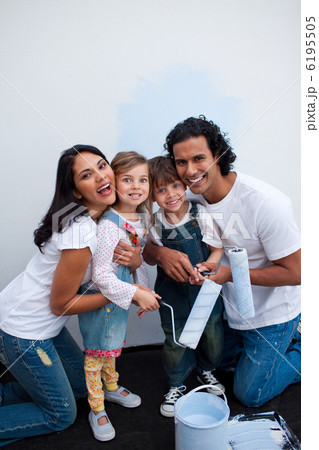 Adorable children painting a room with their parents 6195505