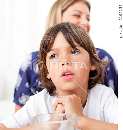 Captivated child watching television with his mother Captivated child watching television with his mother 6196152