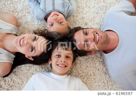 Happy family lying on the floor 6196597