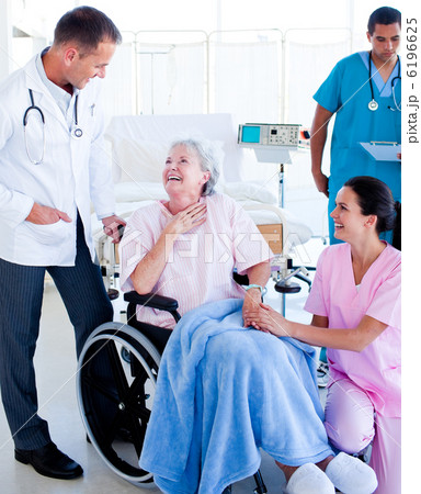 Confident medical team taking care of a senior woman Confident medical team taking care of a senior woman 6196625