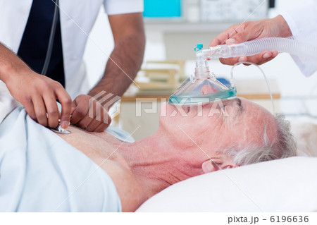 Doctors resuscitating a senior patient 6196636