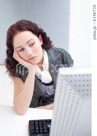 Young businesswoman day-dreaming in office 6196730