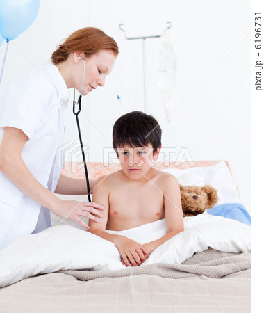 Beautiful doctor examining a little boy 6196731