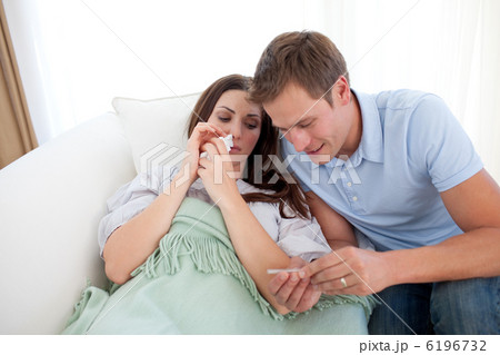 Attentive man taking his wife's temperature 6196732