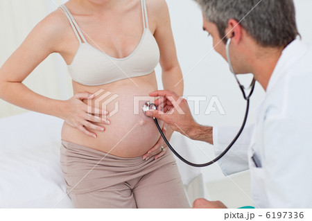 Portrait of a pregnant woman examined by her gynecologist 6197336