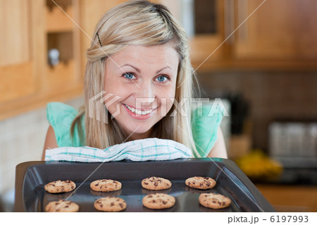 Cute young woman baking cookies Cute young woman baking cookies 6197993