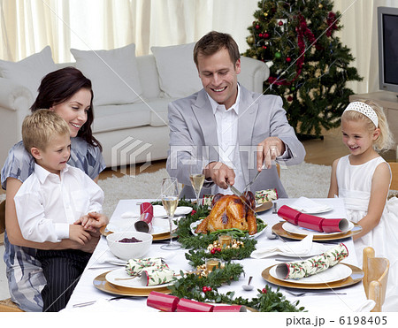 Father cutting a turkey in Christmas dinner Father cutting a turkey in Christmas dinner 6198405