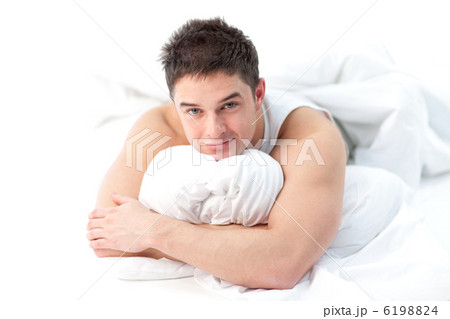 Man lying on bed awake Man lying on bed awake 6198824