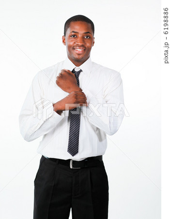 Ethnic businessman corrects a cuff link Ethnic businessman corrects a cuff link 6198886
