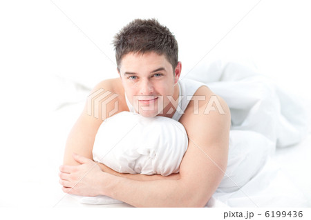 Man lying on bed awake Man lying on bed awake 6199436