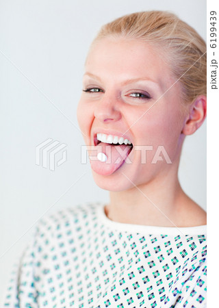 Patient with a pill in her mouth Patient with a pill in her mouth 6199439