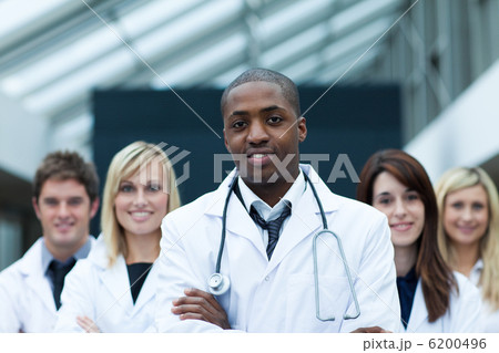 Afro-American doctor leading his team with folded arms 6200496