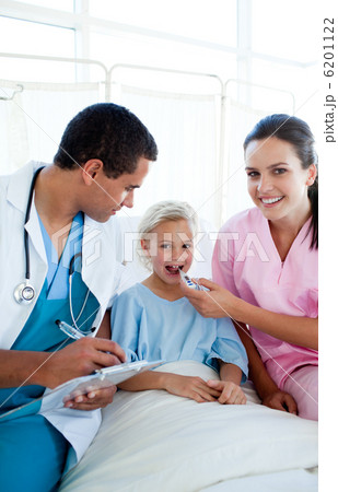 A nurse taking her female patient temperature with a thermometer 6201122