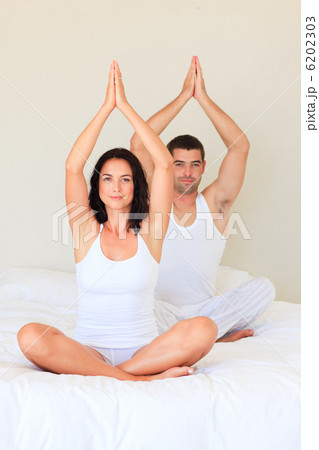 Couple doing yoga in bed 6202303