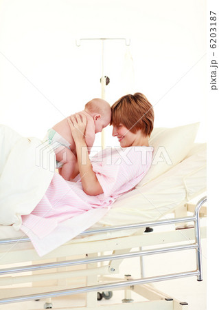 Mother embracing her newborn baby 6203187